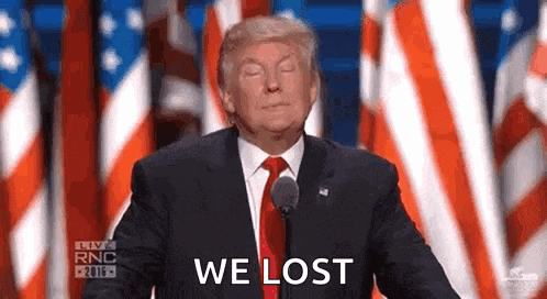 donald trump is giving a speech in front of an american flag while holding a microphone and saying `` we lost '' .