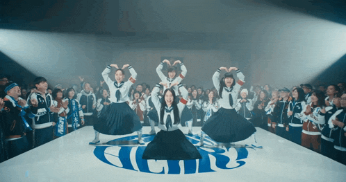 a group of people are dancing in front of a sign that says a.l.r.