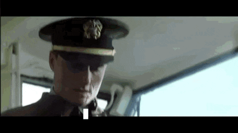 a man in a military uniform is sitting in the back seat of a car .
