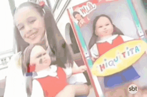 a girl is holding a doll that says hiquita on it