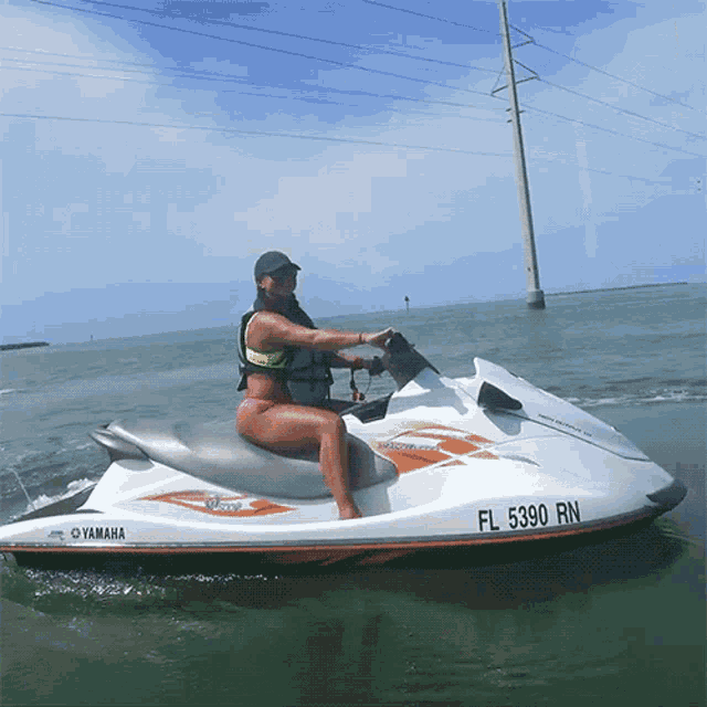 a woman sits on a yamaha jet ski