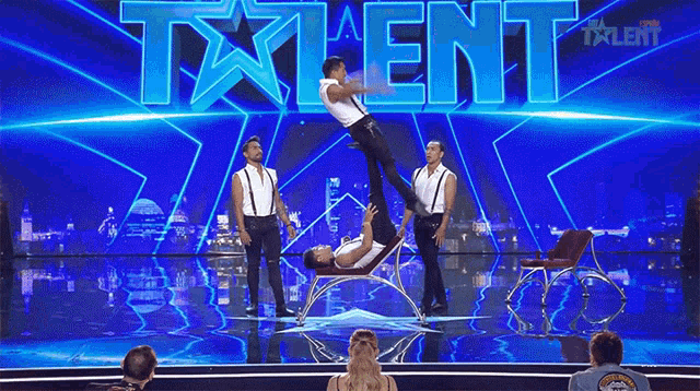 a group of men are performing on a stage in front of the word talent