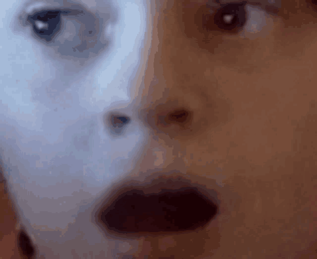 a close up of a person 's face with a reflection of another person 's face .