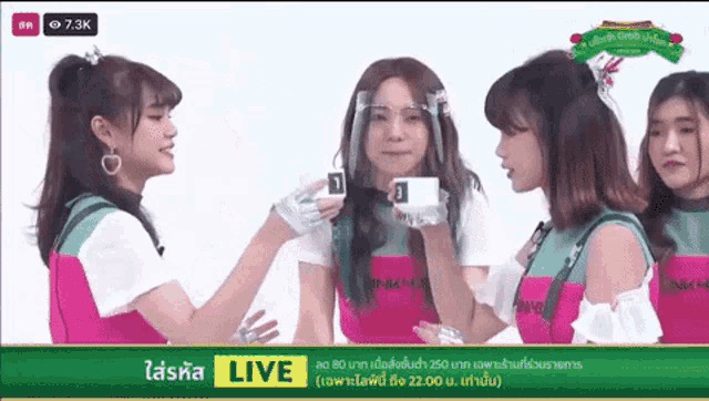 a group of young women are standing next to each other on a live stream