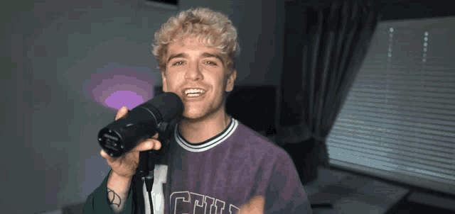 a man wearing a purple shirt with the word chill on it