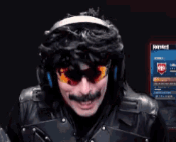 a man wearing headphones and sunglasses is giving a thumbs up sign
