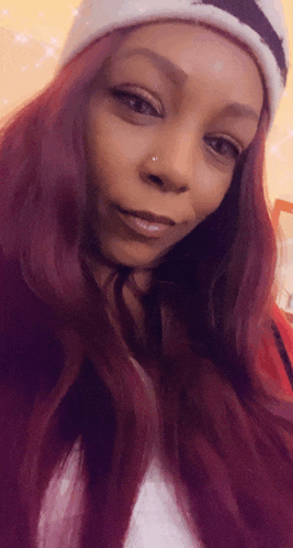 a woman with red hair and a nose ring
