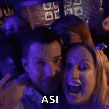 a group of people are posing for a picture and one of them is saying " asi "