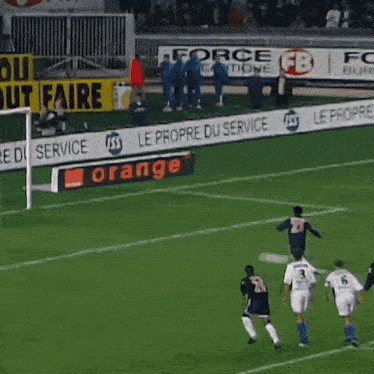 a soccer field with a sign that says " le propre du service "