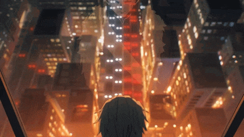 a person is looking out a window at a city at night