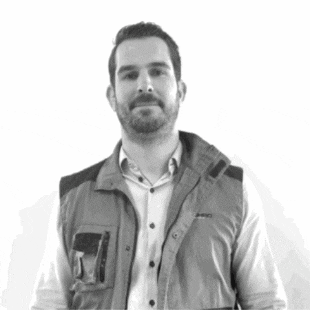 a man with a beard is wearing a vest that says pro