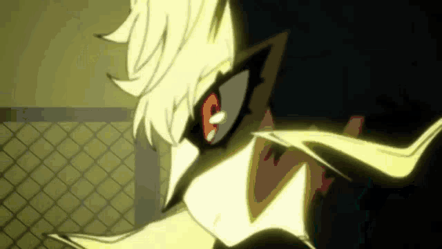 a close up of a person wearing a mask with red eyes .