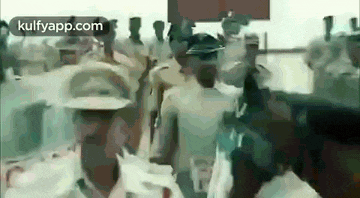 a group of people are walking in a line .