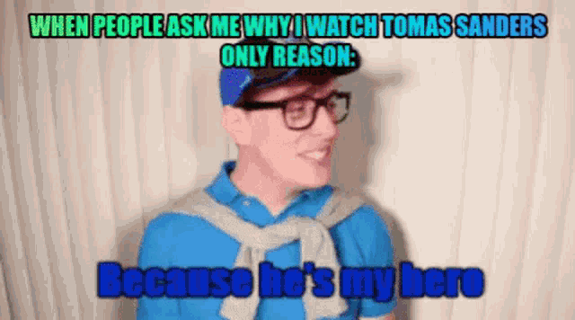 a man wearing glasses and a blue shirt is talking about thomas sanders