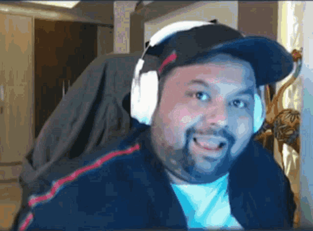 a man with a beard wearing headphones and a hat