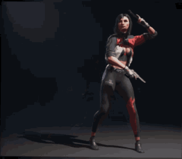 a woman in a red and black outfit is holding a gun and giving a peace sign