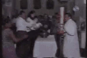 a bride and groom are dancing in front of a crowd at a wedding reception