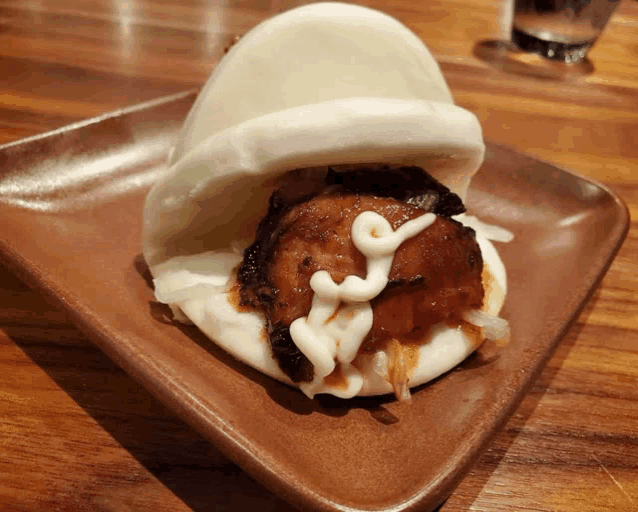 a close up of a sandwich on a plate with mayonnaise on it