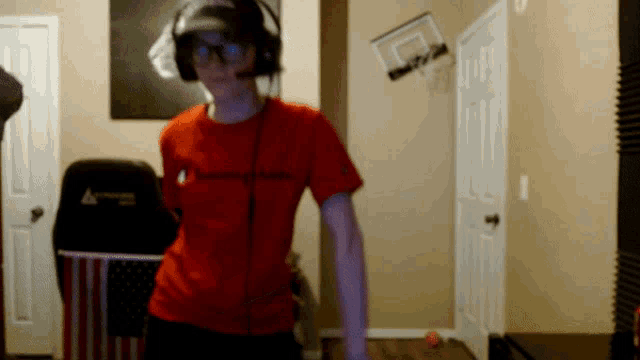 a man wearing headphones and a red shirt that says champion