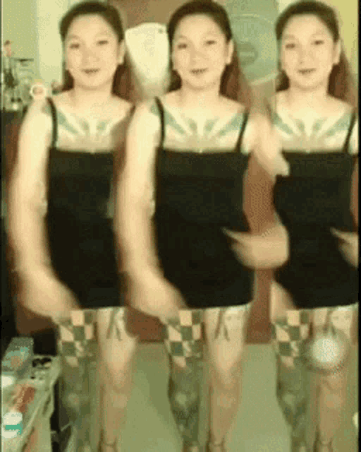 a woman with a tattoo on her arm is dancing in a room
