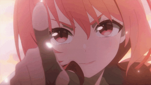 a girl with red hair is pointing her finger at the camera