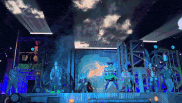 a group of people are standing on a stage with smoke coming out of their mouths