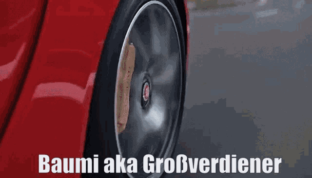 a close up of a car wheel with baumi aka großverdiener written on the bottom