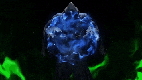 a person is standing in front of a blue sphere in the dark .