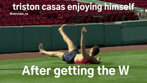 a man laying on the grass with the caption triston casas enjoying himself after getting the w.