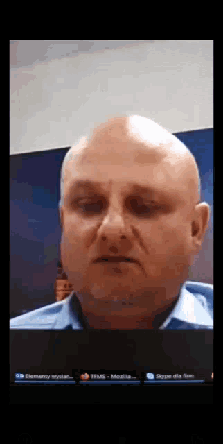 a man with a bald head is on a video call with mozilla