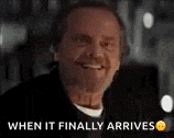 a man is smiling and saying `` when it finally arrives '' in a black and white photo .