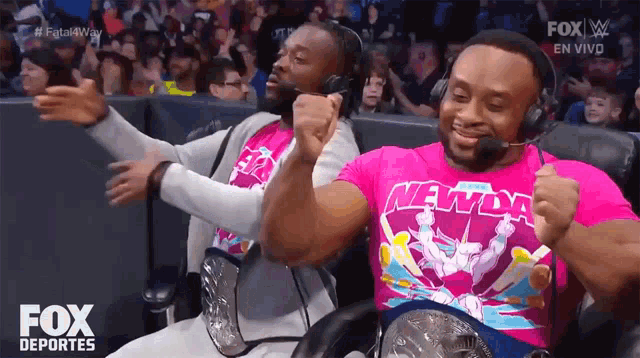 two men wearing headphones and a shirt that says ' new day ' on it