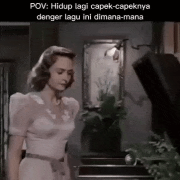 a woman in a white dress is standing next to a piano .