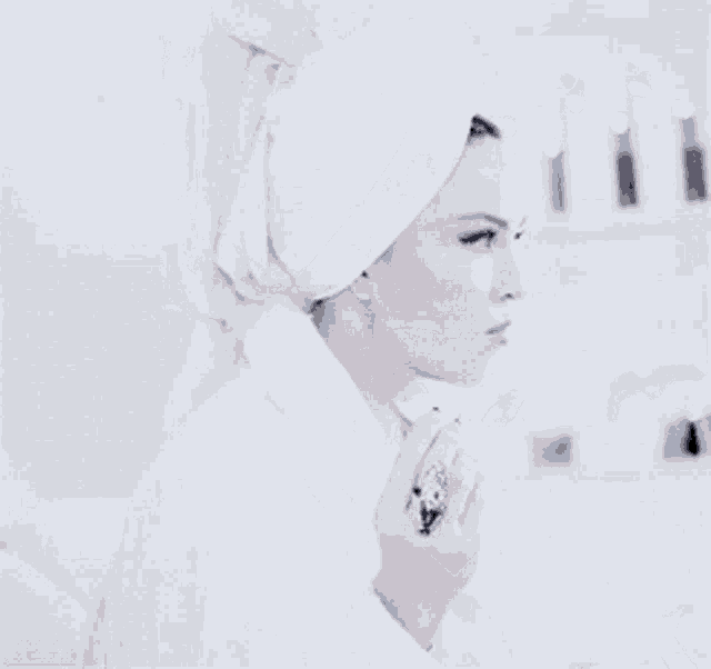 a woman with a towel wrapped around her head holds a cucumber in her hand