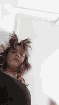 a woman 's head is hanging upside down in a room .