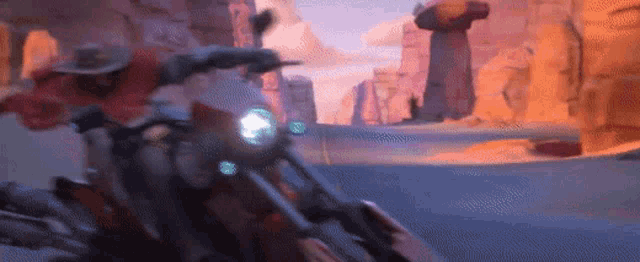 a man is riding a motorcycle down a road in the desert .