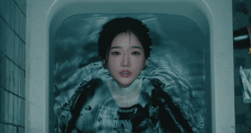 a woman is laying in a bathtub with a shirt that says memory on it