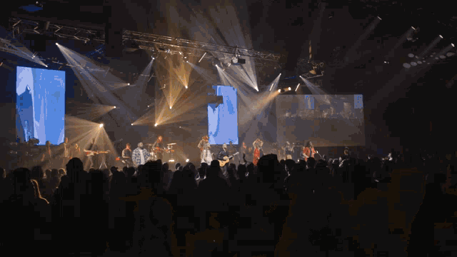 a group of people are playing music on a stage