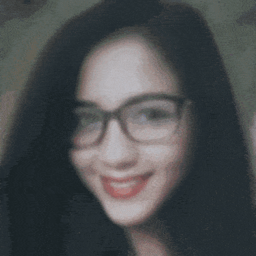 a woman wearing glasses is smiling in a square