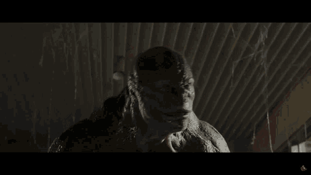 a man in a spiderman costume is crouched down in a hallway