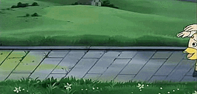 a cartoon character is standing on a sidewalk in front of a green field .
