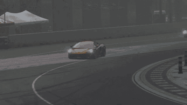 a red sports car is driving down a road