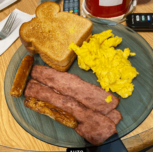 a plate of food with eggs bacon and toast on it