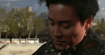 a close up of a man with a scarf around his neck .