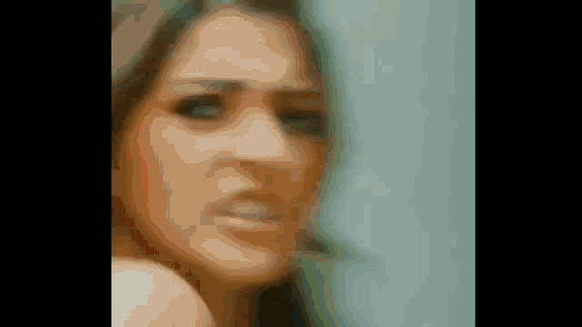 a close up of a woman 's face with a serious expression .