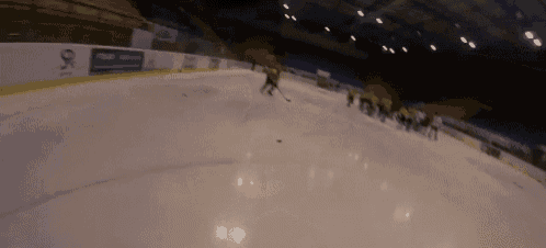 a hockey game is being played on a rink with a sign that says ' sr ' on it