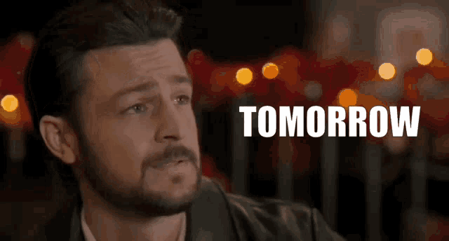 a man with a beard has the word tomorrow written on his face