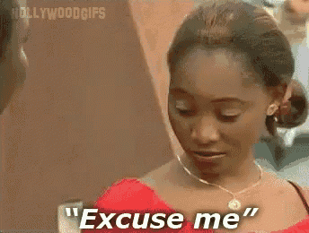 a woman is saying " excuse me " in front of a hollywood gif