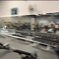 a blurred image of a train going down the tracks with a tiktok logo in the corner .