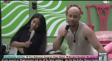 a man is holding a microphone in front of a woman with a flower crown on her head